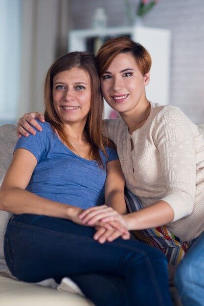 premium photo homosexual couple of lesbian women at home on the couch hugging and enjoying
