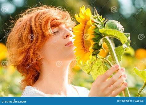 Young Red Haired Girl Admiring The Sunflower Woman Sniffing Sunflower
