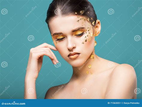 Portrait Of A Beautiful Young Woman With Bright Golden Make Up Stock
