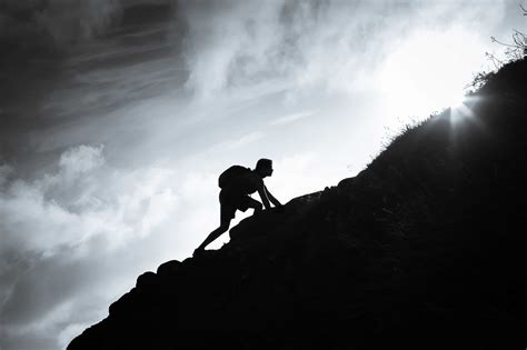 Man Climbing Up A Mountain The Meaningful Life Center