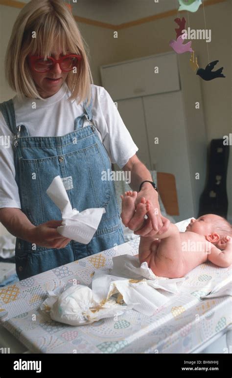 Uk Mother Changing Nappy To Baby Stock Photo Alamy