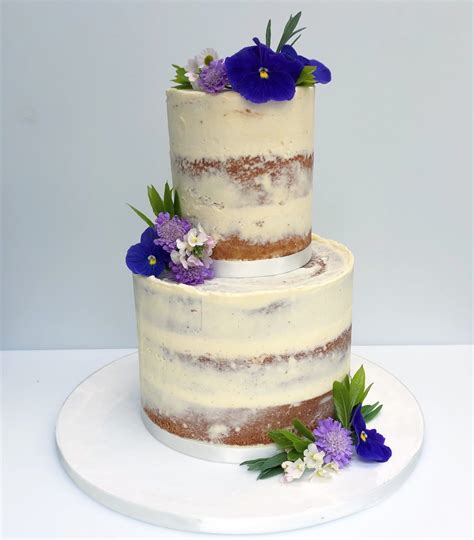 semi naked wedding cake with edible flowers etoile bakery