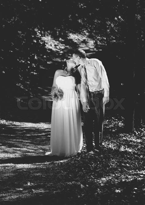Black And White Photo Of Newly Married Couple Kissing Stock Image