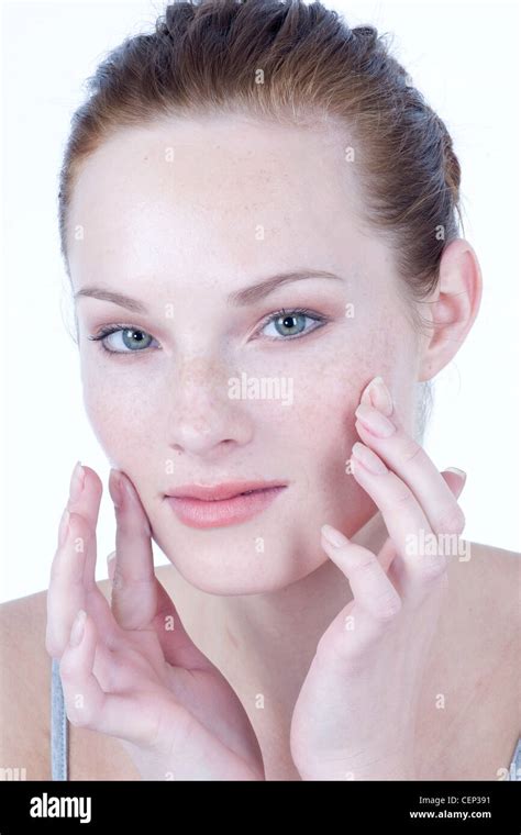 Female Rubbing Cream Into Cheeks With Fingertips Stock Photo Alamy
