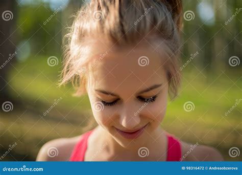 Portrait Of A Young Beautiful Caucasian Woman Smiling And Looking Down