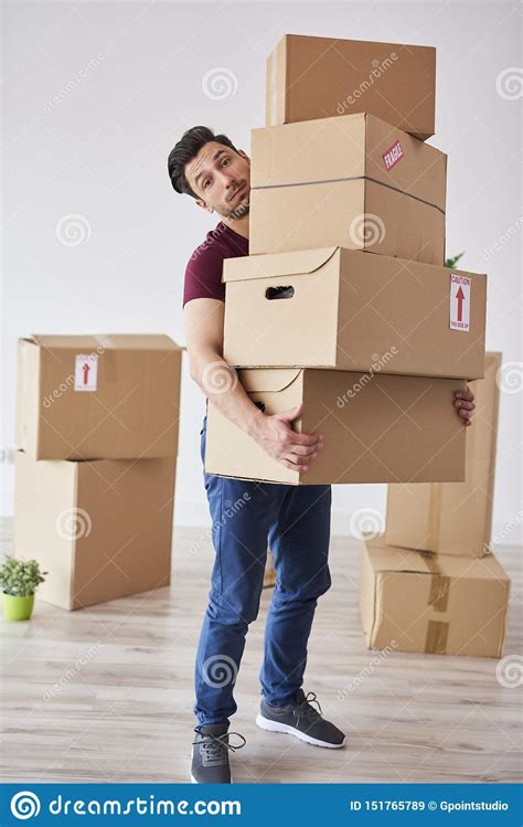 Portrait Of Man Carrying Stack Of Heavy Cardboard Boxes Stock Image ...