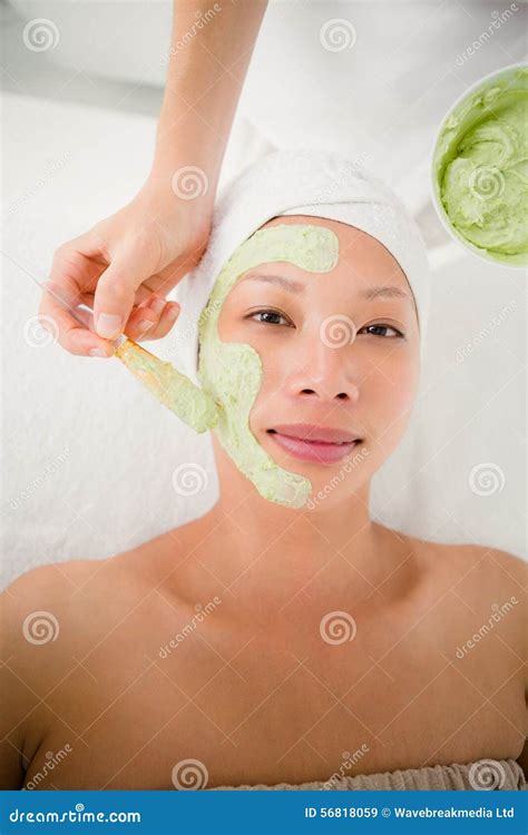 Portrait Of A Beautiful Brunette Getting A Facial Treatment Stock Image