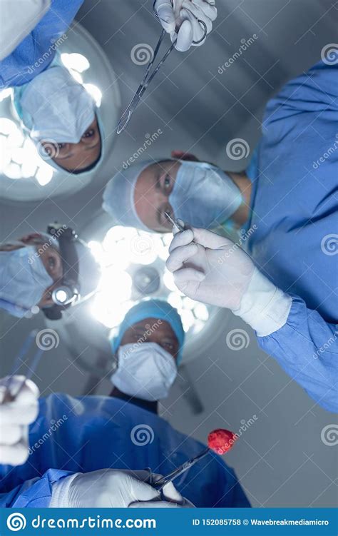 Surgeons Performing Surgery In Operation Theater At Hospital Stock