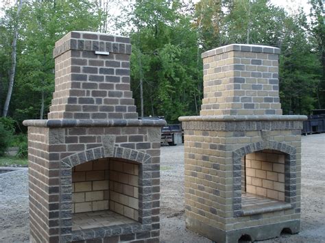 Two Brick Ovens Sitting Side By Side In The Middle Of A Gravel Area