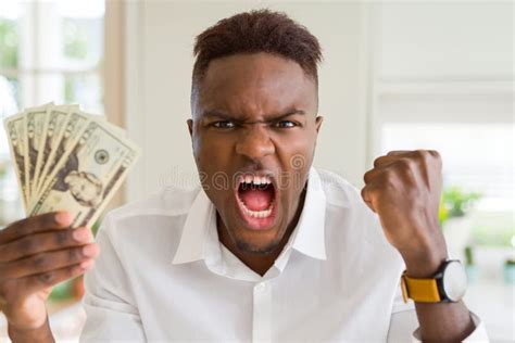 African American Man Holding Twenty Dollars Bank Notes Annoyed And