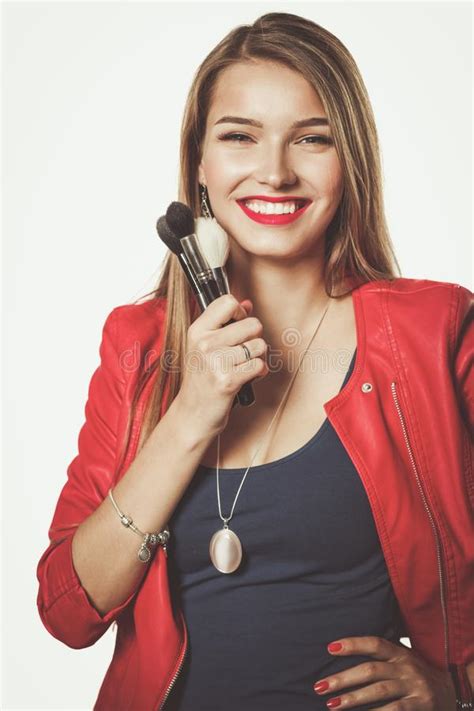 Young Beautiful Woman Holds In Hand Brush For Makeup Stock Photo