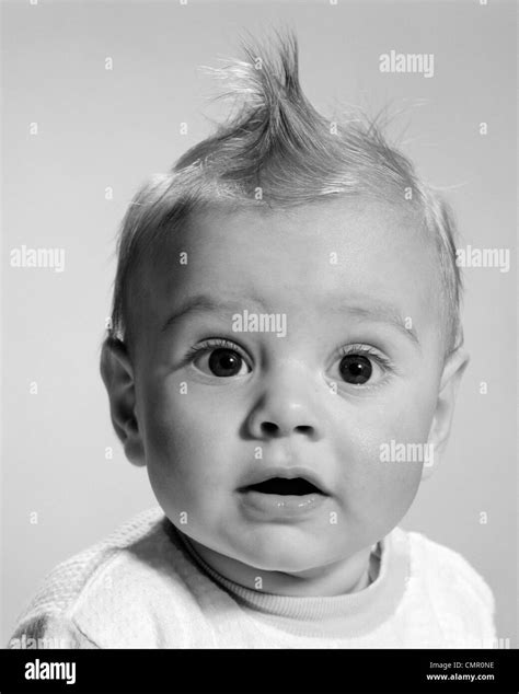 S Close Up Portrait Baby With Wide Eyed Expression With Mouth Open Looking At Camera Stock