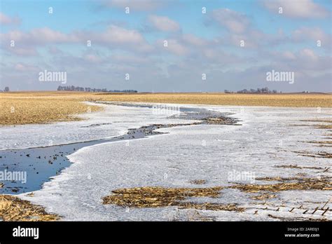 Farm Field After Heavy Winter Rain Storms With Water Turning To Ice As