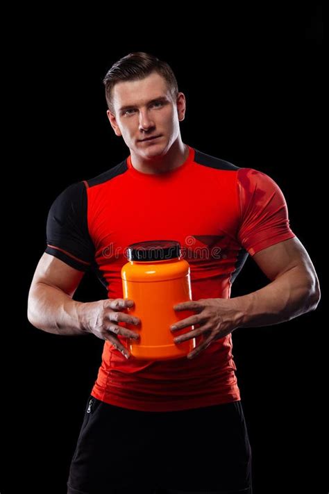 Happy And Healthy Muscular Young Fitness Sports Man With A Jar Of