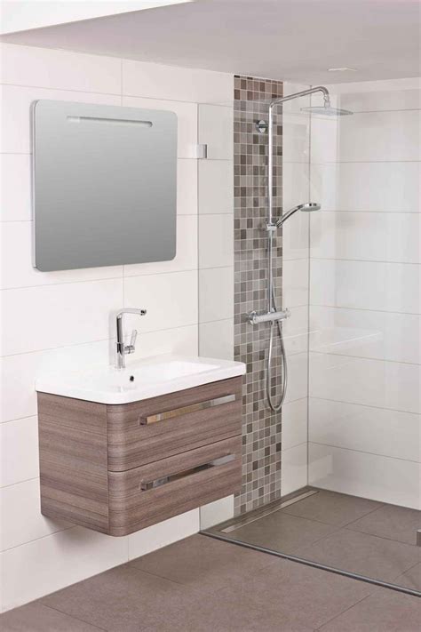 A Bathroom With A Sink Mirror And Shower Stall In The Middle Of The Room