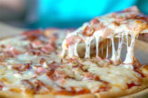 Hot Pizza Slice With Dripping Ham Sausage And Mozzarella Cheese Stock Image Image Of Closeup
