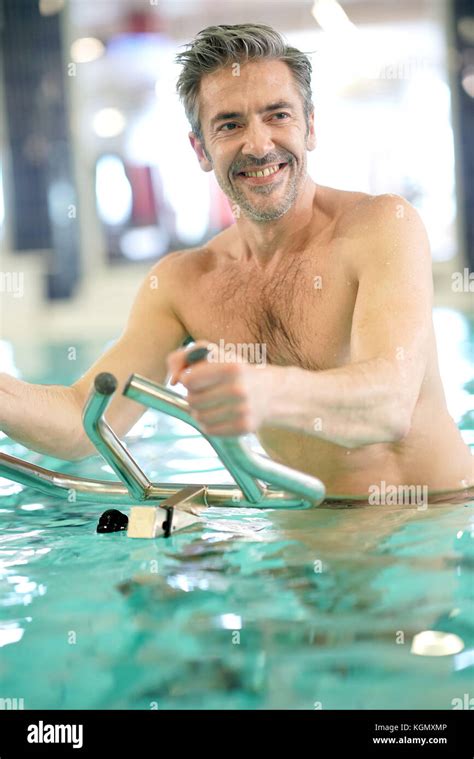 Mature Man In Swimming Pool Doing Aquabike Exercises Stock Photo Alamy