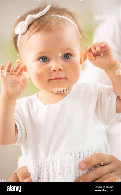 Adorable Small Toddler Girl With Blue Eyes And Blonde Hairwith Her Arms