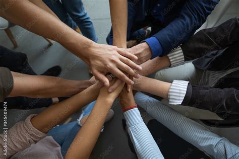 Close Up Mixed Race Business People Putting Hands Together Support And