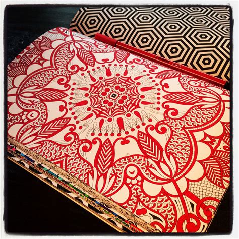 A Red And White Table Cloth With An Intricate Design On It Sitting On