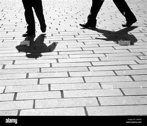 Black And White Silhouette And Shadows Of 2 Businessman Walking In The