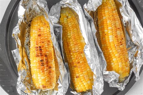 When you remove the husk, your corn is cooked with dry heat, which provides a really nice texture that has the significant difference from boiling that you're looking for. Oven-Roasted Corn on the Cob with Garlic Butter | Ahead of ...