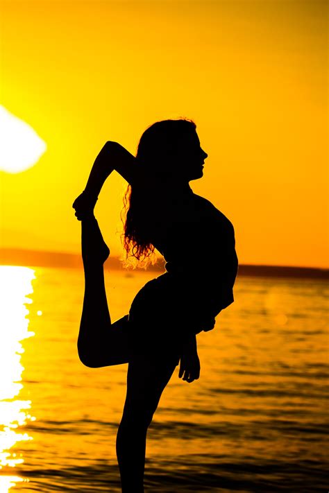 Free Photo Woman Standing On Beach During Sunset Backlit Beach