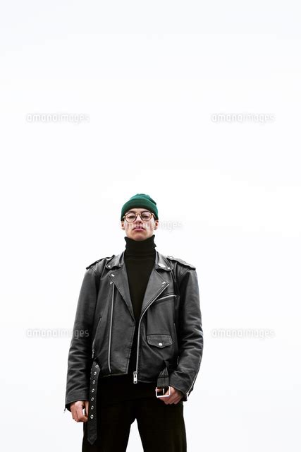 Portrait Of Confident Young Man Standing Against Sky In Foggy Weather