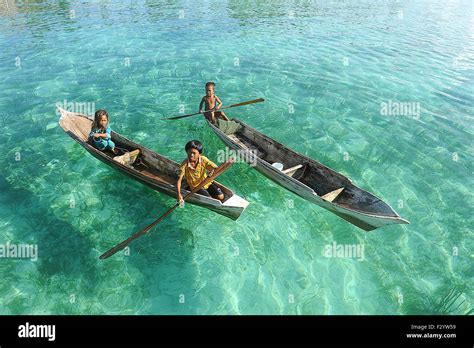 Unidentified Borneo Sea Gypsy Kids On A Canoes In Maiga Island Sabah