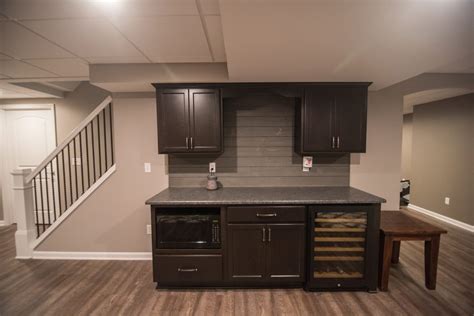 Basement renovation is a great way to incorporate something for everyone in the family. Northville, MI Basement Remodel with Small Bar and Living ...