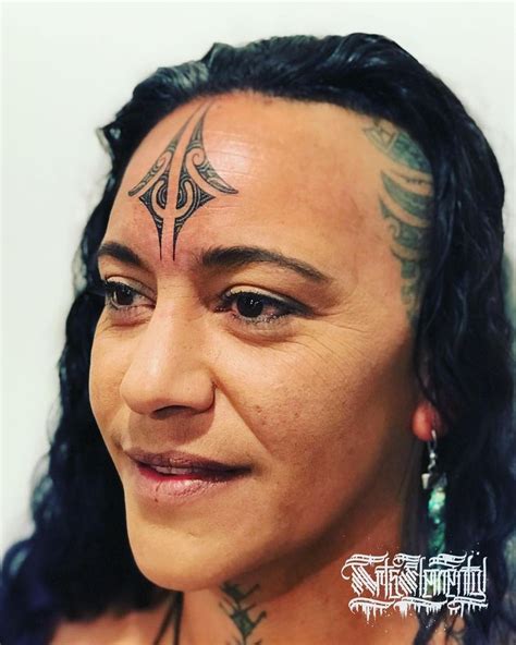A Woman With Tattoos On Her Face And Neck