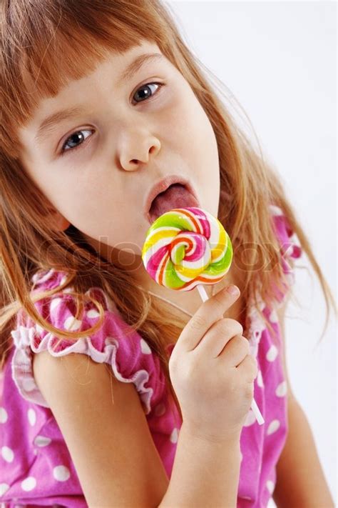 Portrait Of Funny Child Eating Sweet Candy Stock Photo Colourbox
