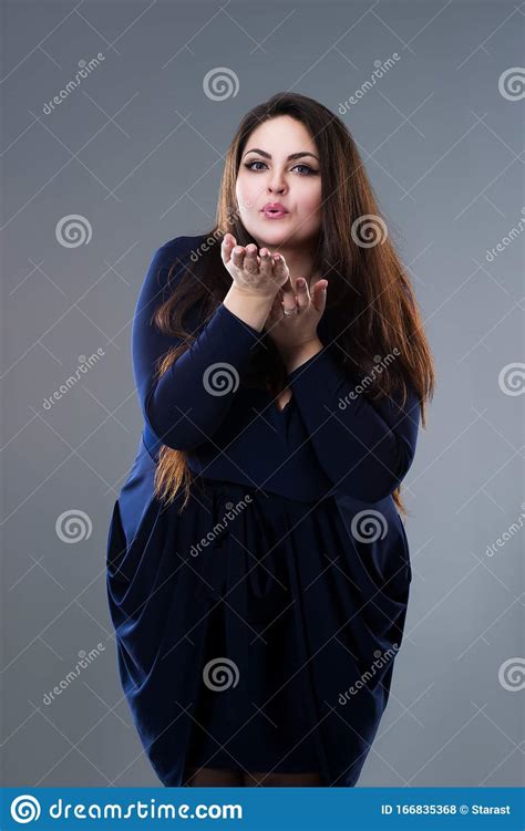 Plus Size Model In Blue Dress Sends Air Kiss Fat Woman With Long Hair On Gray Background Body