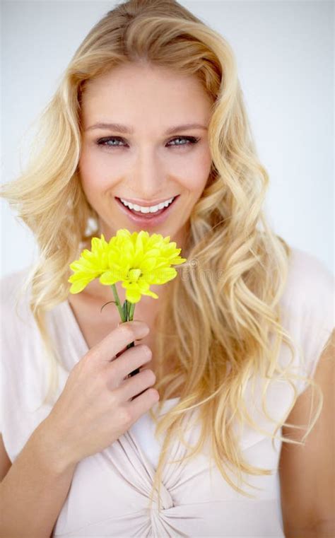 Picture Perfect Portrait Of A Pretty Young Woman Holding A Yellow