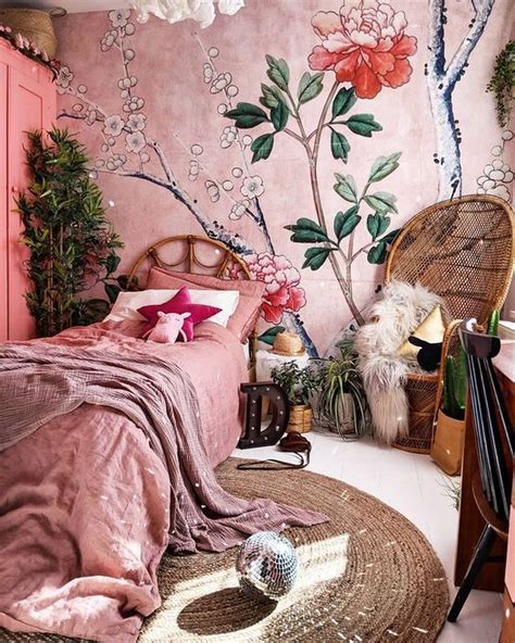 A Bedroom Decorated In Pink And Green With Flowers On The Wall Wicker