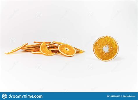 Stack Of Dried Orange Slices And One Slice In Front Bright Light