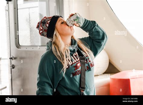 bayfield wisconsin october 19 2019 thirsty blonde woman tourists chugs and drinks a cup of