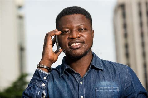 Close Up Of Young African Man With Mobile Phone Happy Stock Image