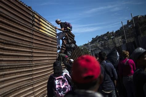 migrants in tijuana run to u s border but fall back in face of tear gas the new york times