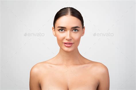 Pretty Shirtless Woman Posing Looking At Camera Over Gray Background Stock Photo By Prostock Studio
