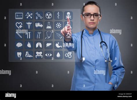 Woman Doctor Pressing Buttons With Various Medical Icons Stock Photo