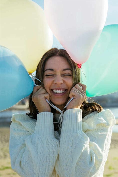 Young Woman Playing With Colorful Balloons Stock Photo