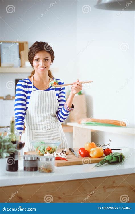 Young Woman In The Kitchen Preparing A Food Young Woman In The Kitchen