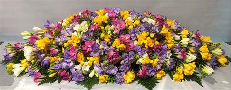 Secure the foam in place by wrapping waterproof floral tape over the top insert greenery into the floral foam to establish the shape of the casket spray and serve as a foundation for flowers. A mixed freesia spray for the top of a casket | Funeral ...