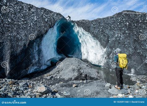 Two Climbing Guides Exploring A Huge Ice Cave On The Matanuska Glacier