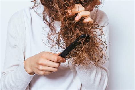 woman combing tangled hair