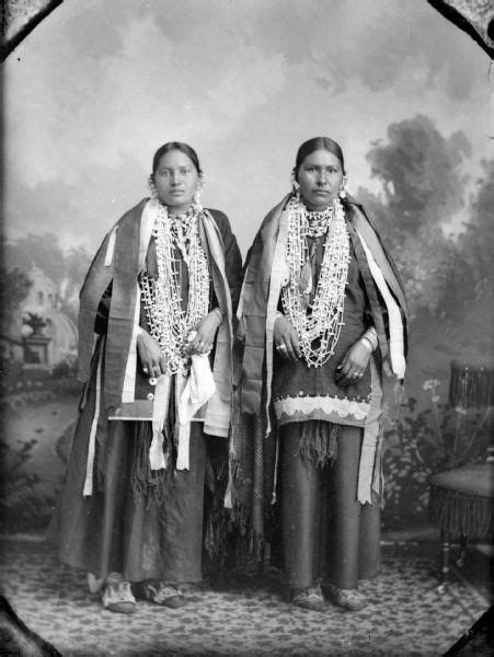 Two Native American Women Standing Next To Each Other