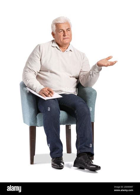 Senior Male Psychologist Sitting In Armchair On White Background Stock