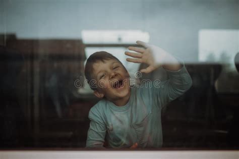 Happy Little Boy Waving Through Window To Say Goodbye When Travelling