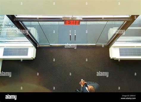 Double Large Glass Doors And Exit Sign In High Rise Building In Nyc